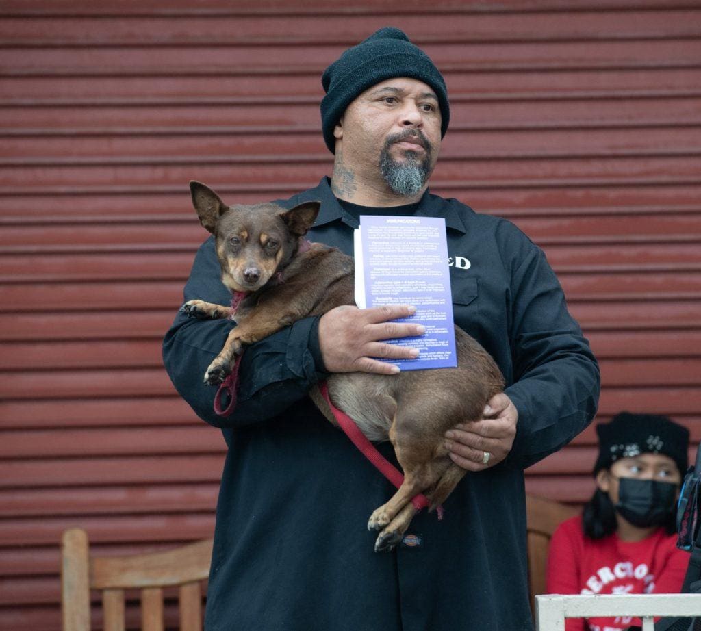 man holding his dog at bnp event